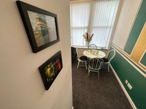 a small dining room with a table and chairs at Emerald Apartment Pleasure Beach Blackpool in Blackpool