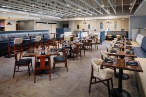 a large dining room with tables and chairs at DoubleTree by Hilton Ann Arbor, MI in Ann Arbor