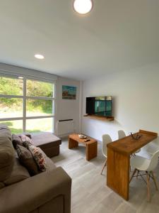 a living room with a couch and a table at Casa SobreMonte in Muxia