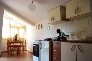 een keuken met een witte koelkast en een tafel bij House of peace in Podgorica