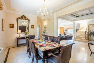 a dining room with a table and chairs and a chandelier at Villa Denise in Pouládes