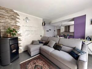 a living room with a couch and a fireplace at Residenza Basilica in Tirano