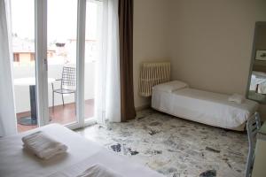 Postel nebo postele na pokoji v ubytování Hotel Arianna