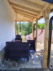 a wooden pergola with two chairs and a table at Stari Hrast 1 in Prolomska Banja