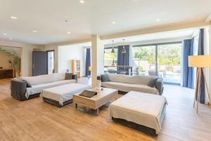 a living room with two couches and a table at Villa Eleanna in Agnítsini +56 photos