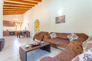 a living room with a couch and a table at Villa Popi in Roda