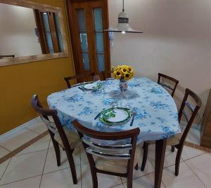 a dining room table with a blue and white table cloth at Apartamento Completo 2 Quartos Wi-Fi 300 Mbps in Porto Alegre