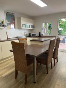 a kitchen with a wooden table and chairs at Casa de Limon in Palma de Mallorca