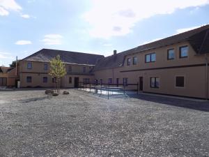 a building with a tennis court in front of it at Heidehotel Jagdhof Dobra GmbH in Dobra