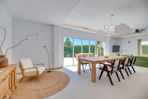 a dining room with a wooden table and chairs at VB Higueron 4BDR Villa w Pool, Cinema & Ping pong in Benalmádena