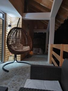 a room with a rattan chair on a patio at Stari Hrast 2 in Prolomska Banja