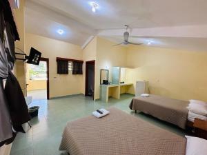 a hotel room with two beds and a bathroom at Cabañas Marisol in Palenque +38 photos