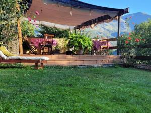 a gazebo with chairs and a bench in a yard at Casa Macianet in Beranui