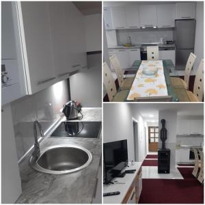 uma cozinha com armários brancos, um lavatório e uma mesa em AQUA VET em Velika Kladusa