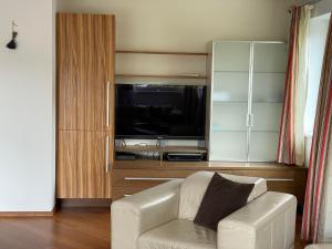 a living room with a couch and a flat screen tv at Ferienhaus Altenmarkt, Kaulfersch in Altenmarkt im Pongau