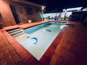a swimming pool with a dolphin painted on it at Welcome Estate Air B&B Hosting in Cape Town
