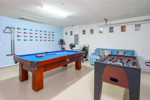 a room with a pool table and a couch at Spacious Vacation Home Near Disney w/ Private Pool- Perfect for Families! in Davenport