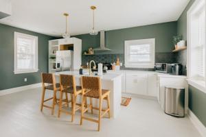 a kitchen with green walls and a table and chairs at Newly Renovated Vintage Inspired Large 4 BR Home in Mount Joy
