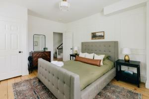 a bedroom with a large bed and a mirror at Newly Renovated Vintage Inspired Large 4 BR Home in Mount Joy