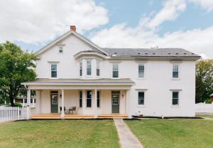 a white house with a large yard at Newly Renovated Vintage Inspired Large 4 BR Home in Mount Joy