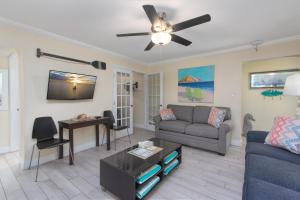 a living room with a couch and a ceiling fan at Clearwater Beach Suites 204 condo in Clearwater Beach