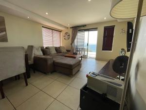 a living room with a couch and a table at Nautica Flat 301 in Mossel Bay