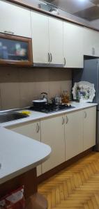 a kitchen with white cabinets and a counter top at Уютная трехкомнатная квартира с видом на море в Баку in Baku