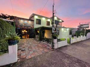 a house with a white fence in front of it at Hotel Punta Descartes in La Cruz