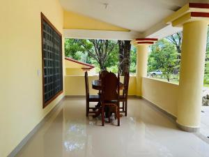 a porch with chairs and a table in a house at Cabañas Marisol in Palenque