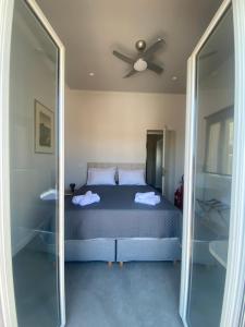 1 dormitorio con 1 cama y ventilador de techo en Serendipity Living, en Citera