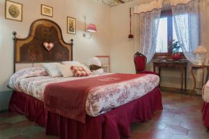 um quarto com uma cama grande e um cobertor vermelho em Residenza Mordini em La Maddalena