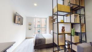 a bedroom with a bed and a book shelf at CityScape Loft Calle 85 in Bogotá