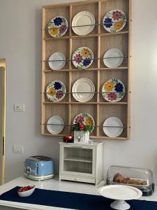 a shelf with plates on a wall with a microwave at B&B La Terrazza in Pozzolengo