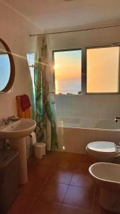 a bathroom with a sink and a tub and a toilet at Paraiso da Pedreira in Nordeste +13 photos