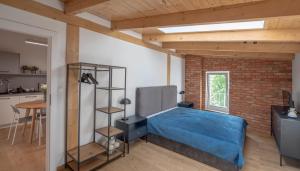 a bedroom with a bed and a brick wall at Apartamenty Młyńska 5 in Bielsko-Biała
