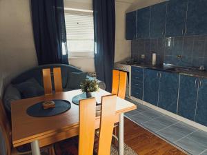 Kostolac的住宿－Apartment White Angel，一间带木桌的厨房和一间餐厅