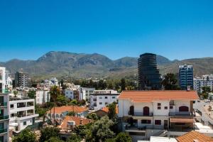 a city with buildings and mountains in the background at Royal Homes in Kyrenia