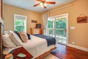 a bedroom with a bed and a sliding glass door at Rustic Retreat in Cadiz On Lake Barkley in Cadiz