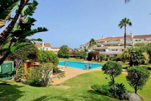 a view of a swimming pool in a resort at FlordeTajinaste in Puerto de la Cruz