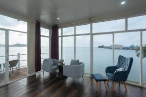 a living room with a view of the water at Seaward 270 degrees deluxe ocean view room with queen bed in Koror