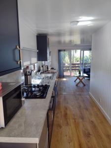 a kitchen with a stove and a counter top at Lagavulin 3 in Portpatrick