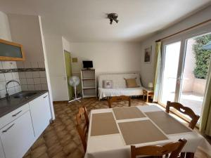 cocina y comedor con mesa y habitación en Mon oranger, en Claira