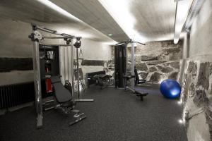 a room with a gym with a blue ball and weights at Färna Herrgård & Spa in Färna
