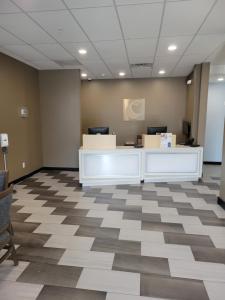 an office with a reception desk and a checkered floor at Comfort Inn Miramar Beach-Destin in Destin