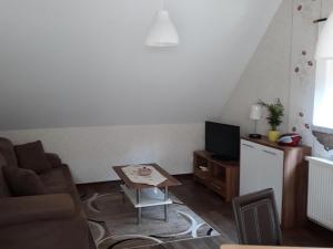 a living room with a couch and a table at Apartment near Altdöbern Castle & Spreewald in Altdöbern