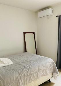 a bedroom with a bed with a mirror and a heater at Cerca de todo! Ubicación estratégica in Godoy Cruz