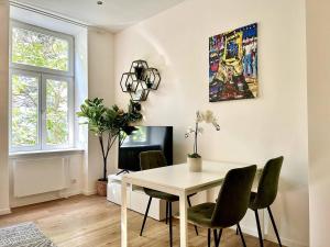 a dining room with a table and chairs at Modern Stylish Studio near Center in Vienna