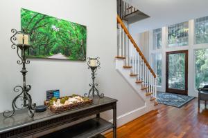 a living room with a staircase and a painting on the wall at 2873 Hidden Oak Drive in Seabrook Island