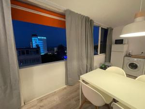 a kitchen with a white table and a window at Apartamento C y L in Torremolinos