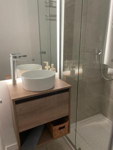 a bathroom with a sink and a glass shower at Apartamento C y L in Torremolinos